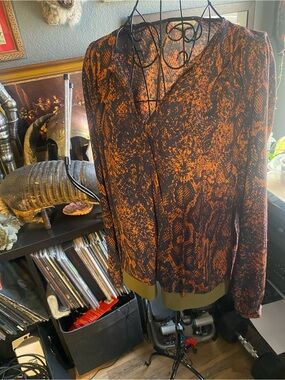 Navy blue and orange snake print top with olive trim